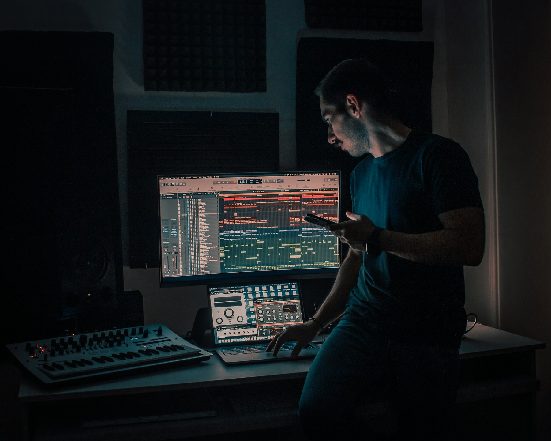 A person in a black t-shirt sitting at a computer