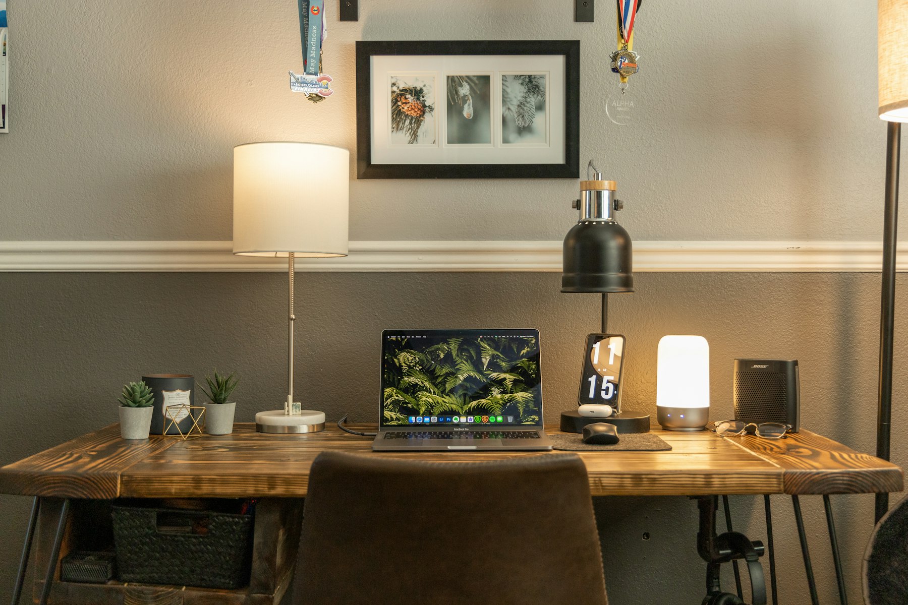 A laptop and a lamp on a desk in a quiet studio